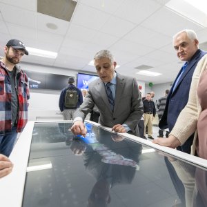 expert demonstrating the Anatomage table technology for a group of viewers